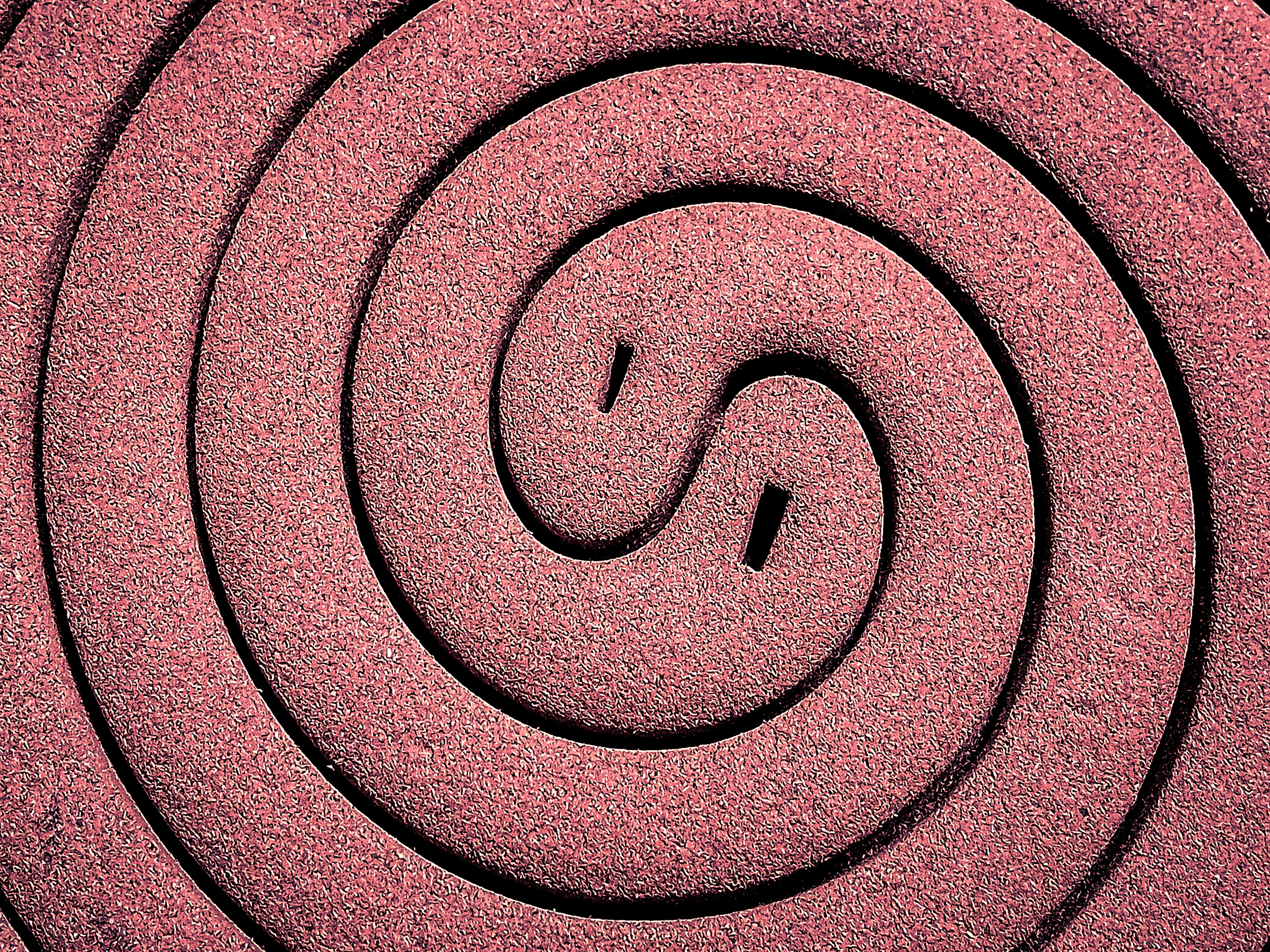 A close up of a circular object made out of sand photo Free Spiral Image on Unsplash