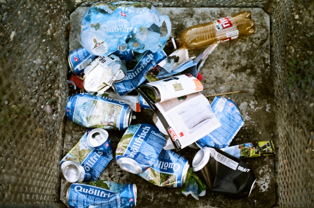 a pile of trash sitting on top of a sidewalk