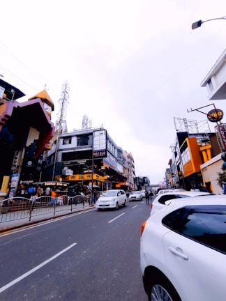A busy street with various vehicles parked along the curb.
