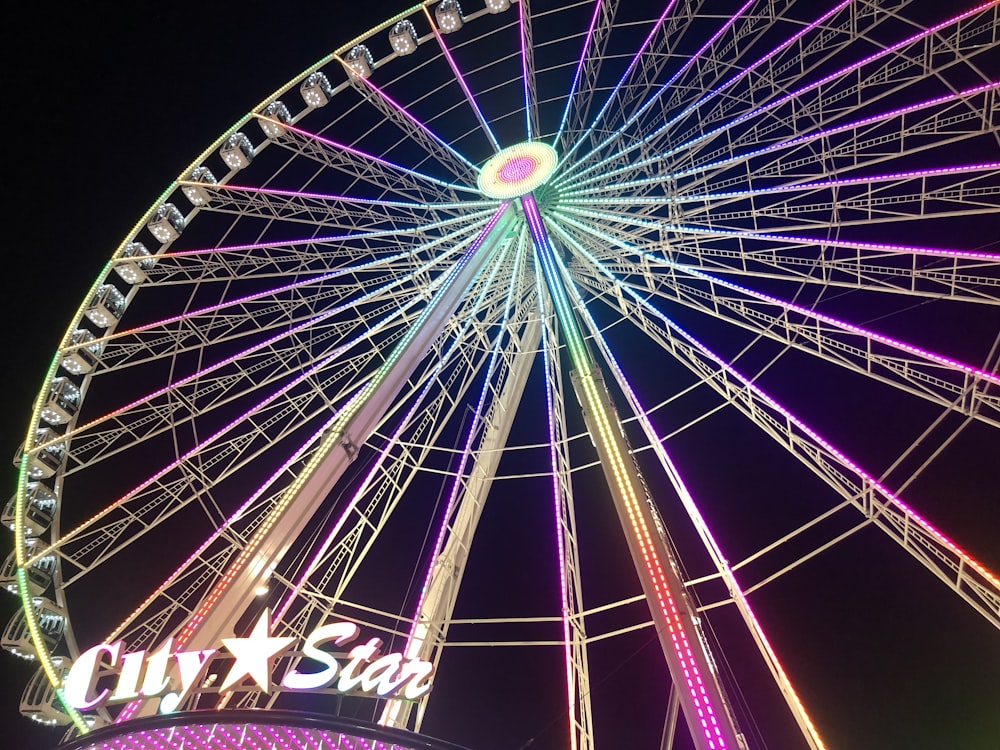 a large ferris wheel lit up at night