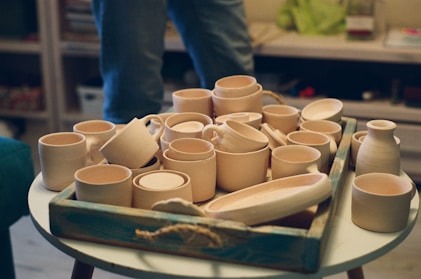 a tray of pottery sitting on top of a table