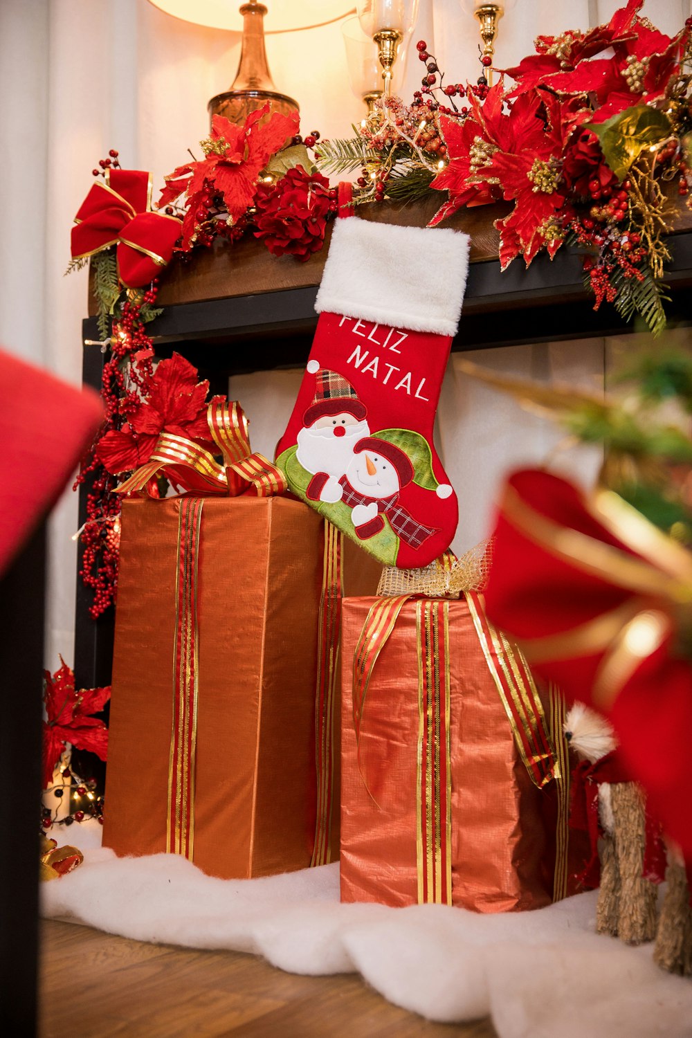 a christmas stocking and presents are sitting in front of a fireplace