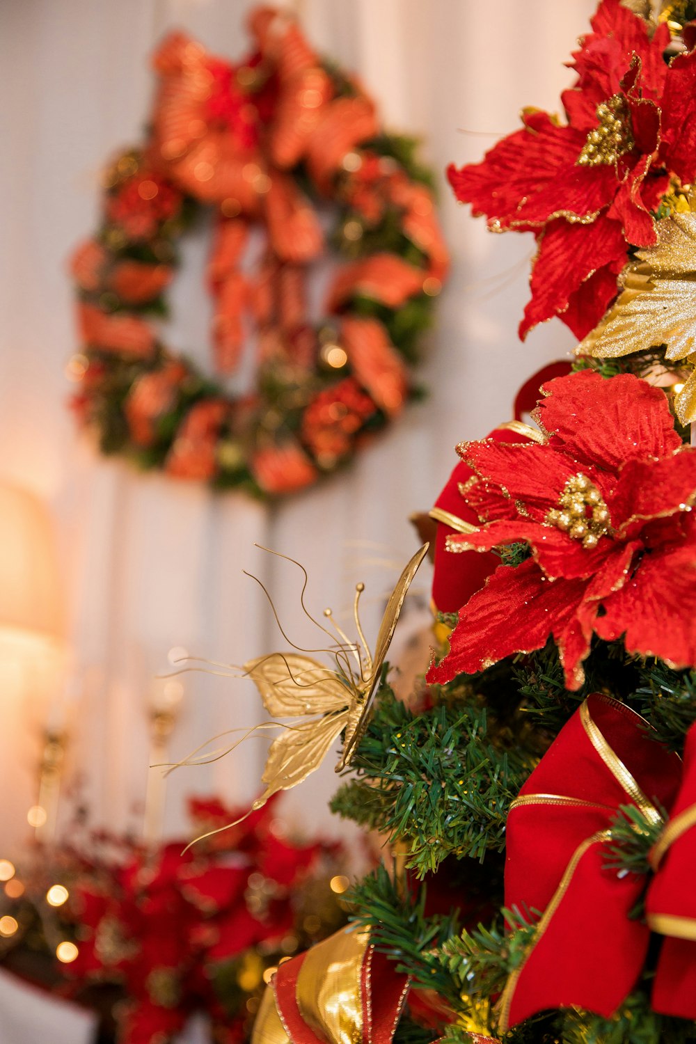 a christmas tree decorated with red and gold poinsettis