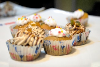 a close up of cupcakes with frosting and sprinkles