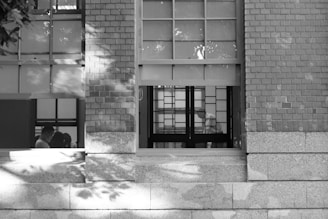Minimalistic black and white photo of Tom Bremen and Theo Somorjay working together in a modern office.