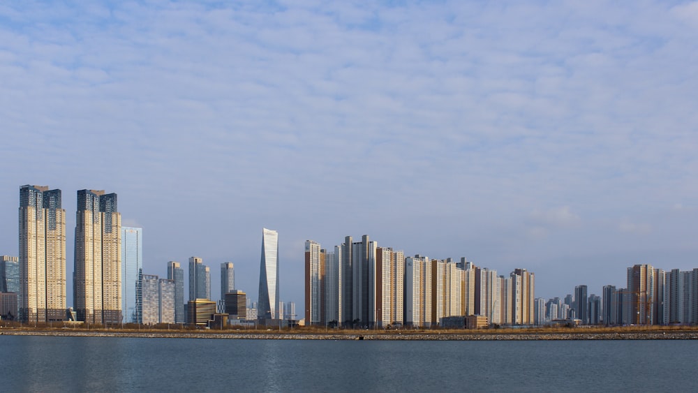 a large body of water with a city in the background