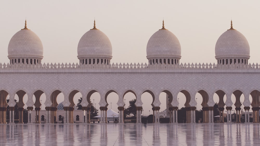 a large white building with arches and domes