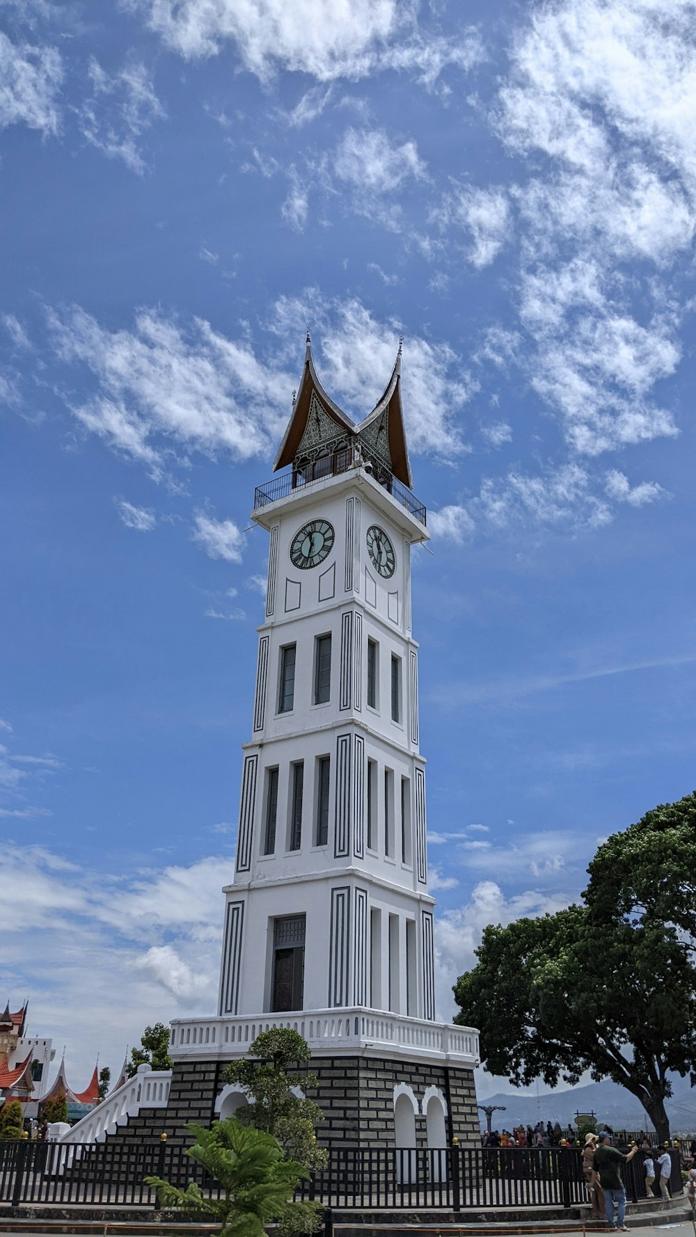 Una alta torre de reloj blanca con un fondo de cielo