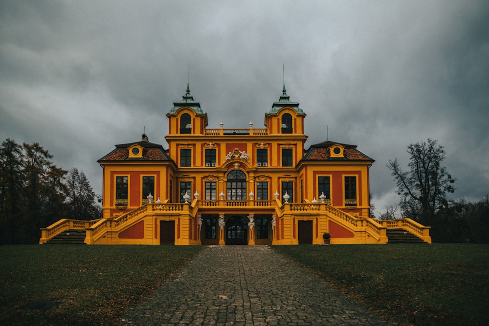 a large yellow building with two towers on top of it