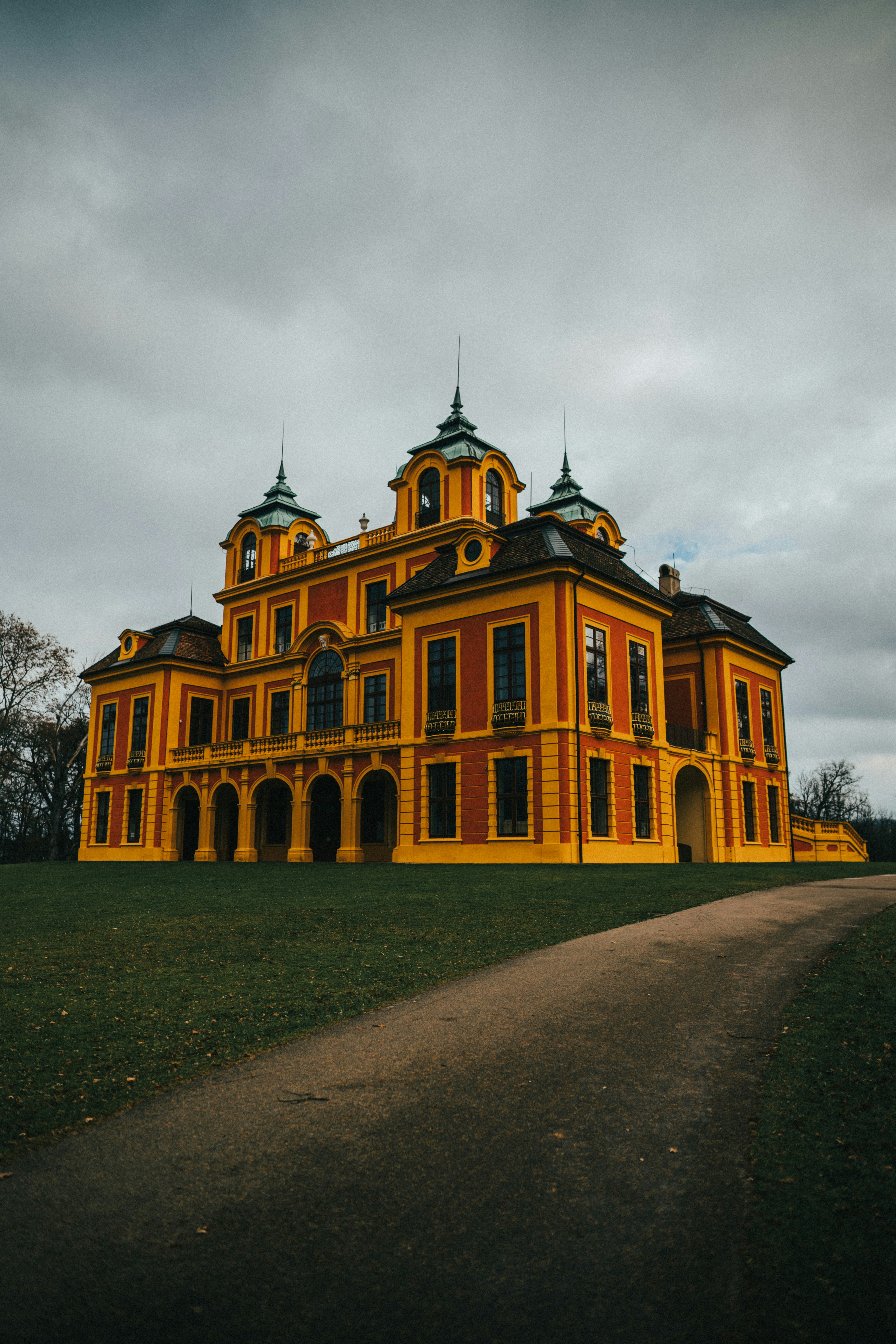 a large yellow building with two towers on top of it
