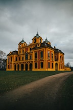 a large yellow building with two towers on top of it