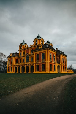 a large yellow building with two towers on top of it