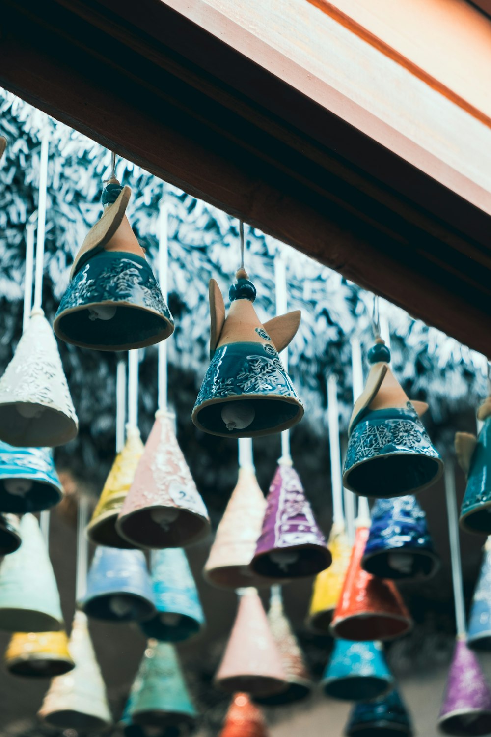 a group of bells hanging from a ceiling