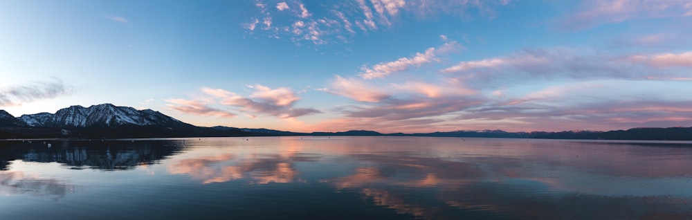 a large body of water with mountains in the background