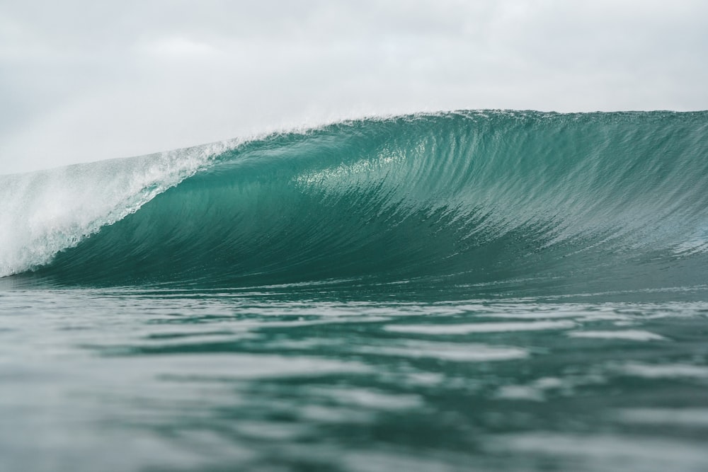 a large wave in the middle of the ocean