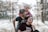 a man holding a little girl on his shoulders