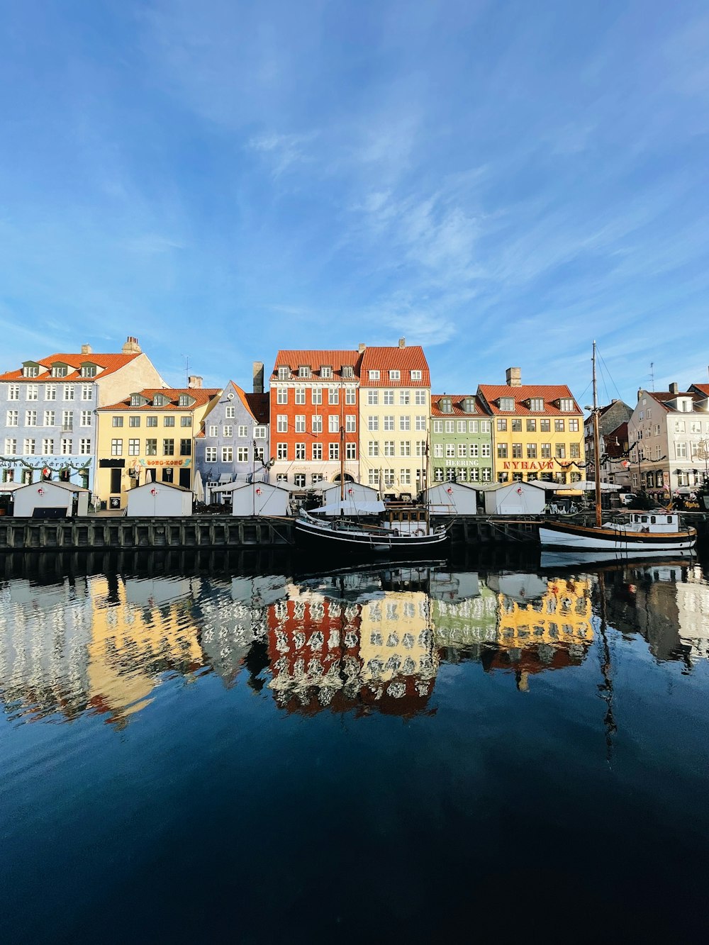 a group of buildings sitting next to a body of water