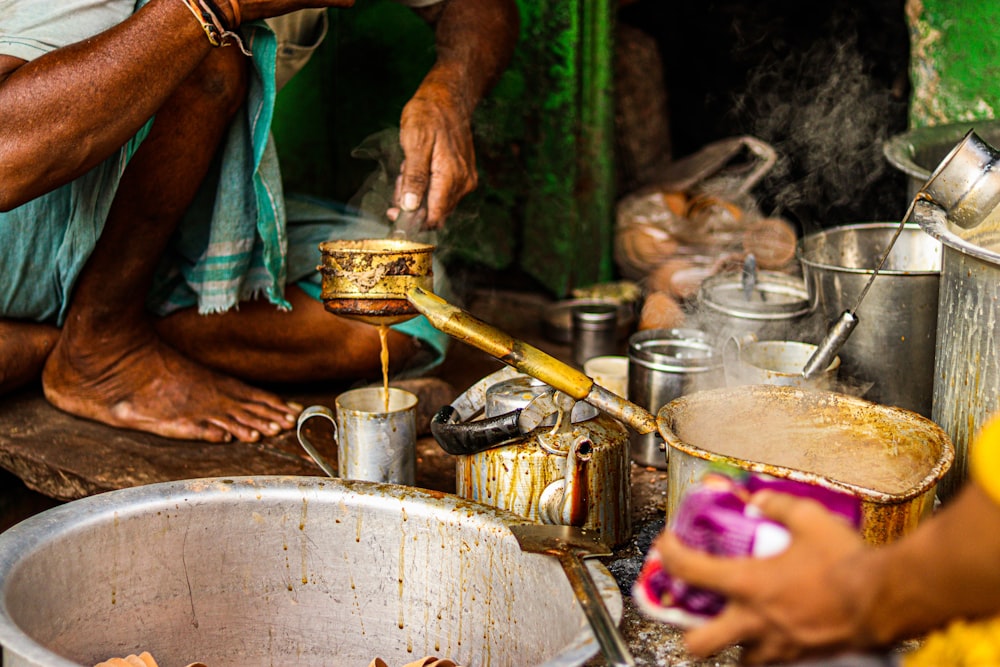 a man is pouring something into a bowl