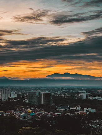 a view of a city with mountains in the distance