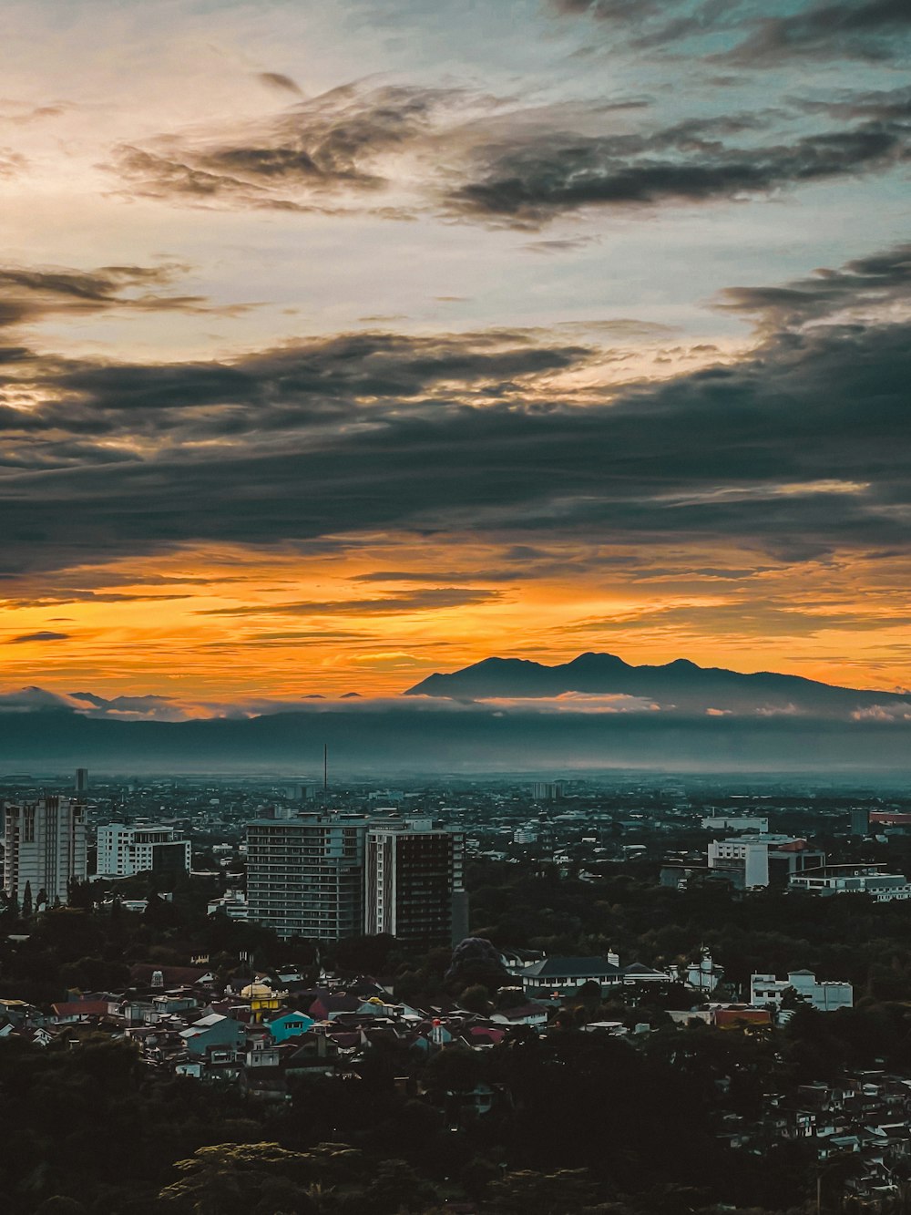 a view of a city with mountains in the distance