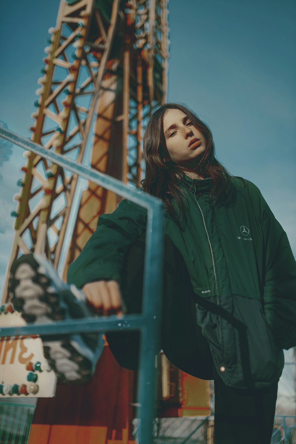 a woman standing in front of a ferris wheel