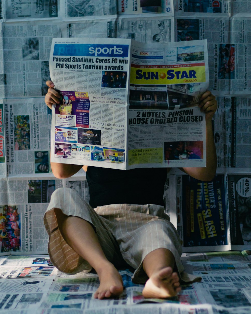 a person sitting on a newspaper