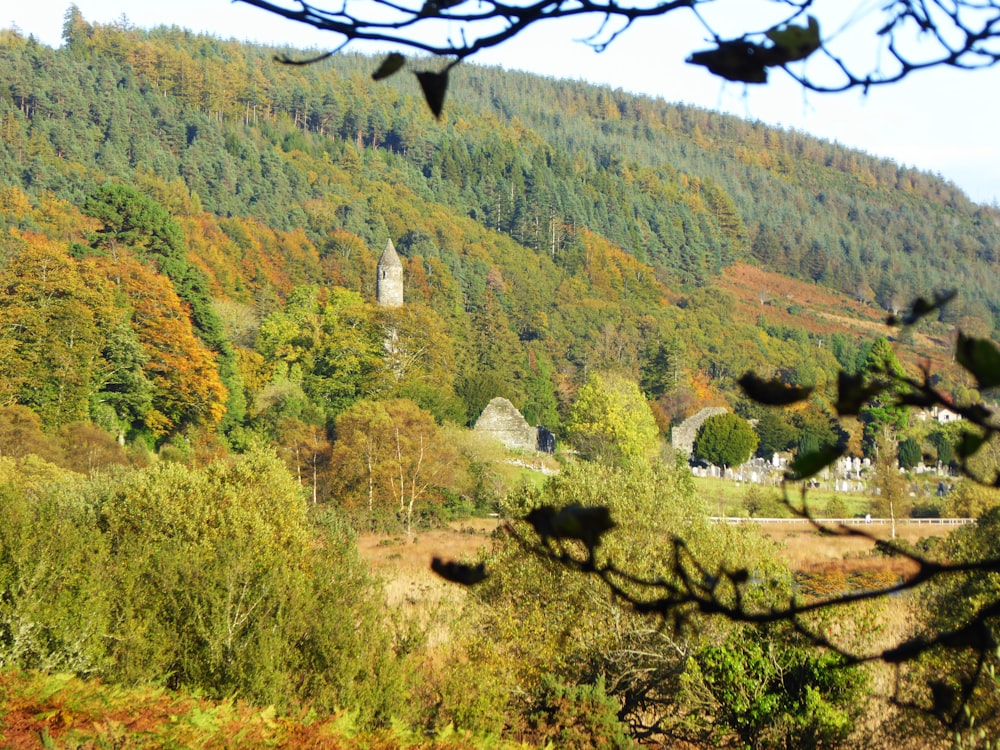 a scenic view of a mountain with a church in the distance