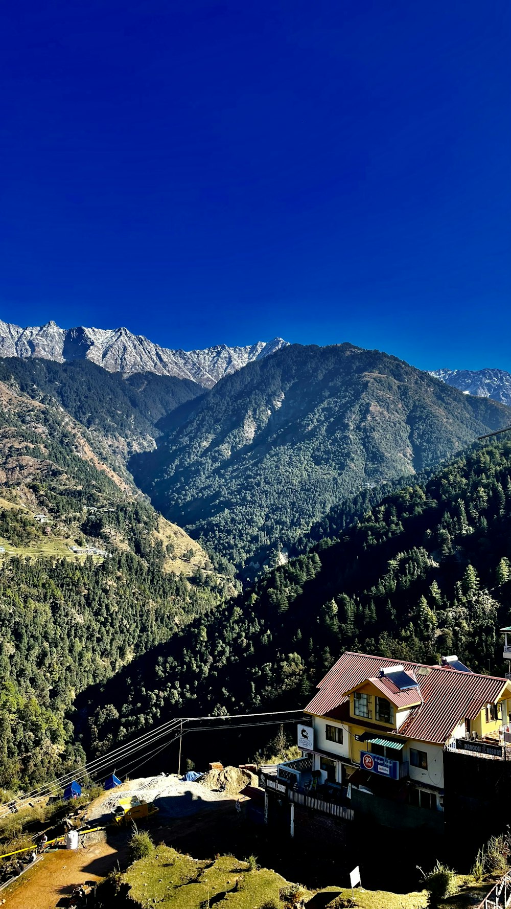 a view of a mountain range with a house in the foreground