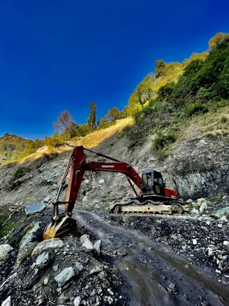 an excavator digging through a rocky area