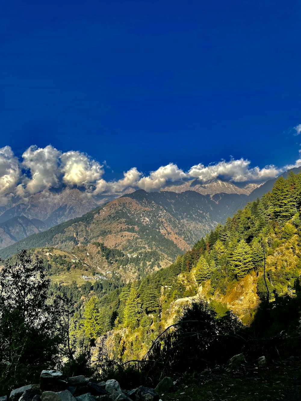 a view of a mountain range with clouds in the sky