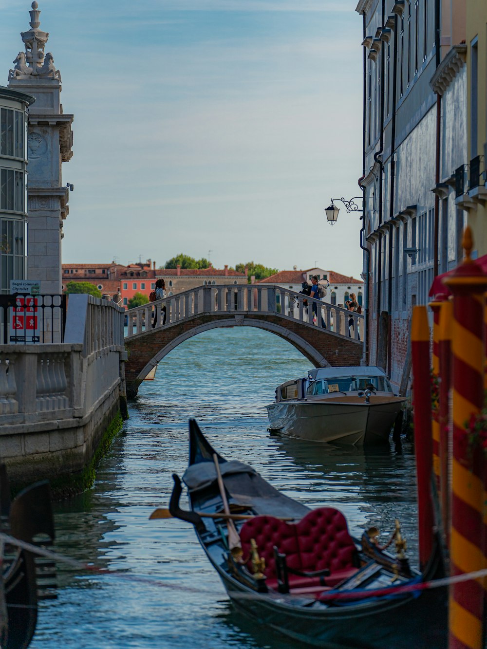 a boat traveling down a river next to a bridge