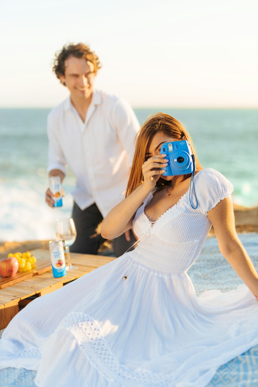 a man taking a picture of a woman with a camera