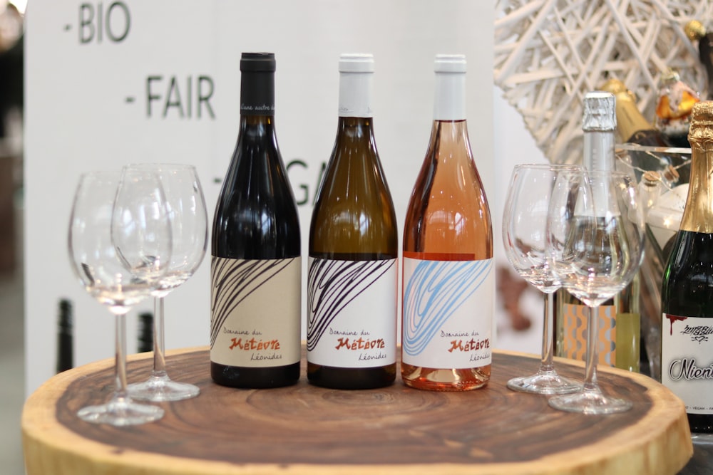 a group of wine bottles and glasses on a table