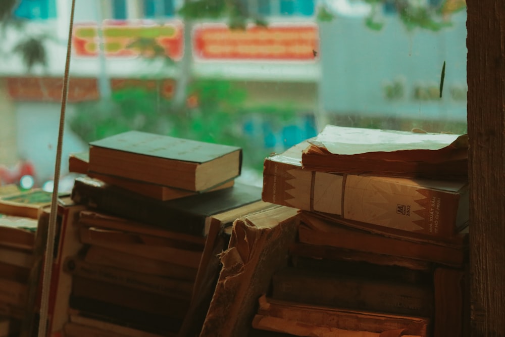 a stack of books sitting on top of a wooden table