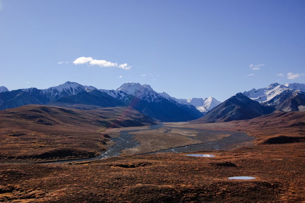 a view of a valley with mountains in the background