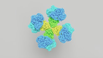 a bunch of blue and green flowers on a gray background