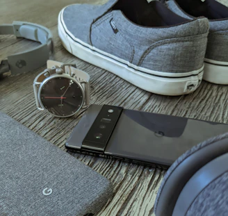a pair of shoes and a smart phone on a table