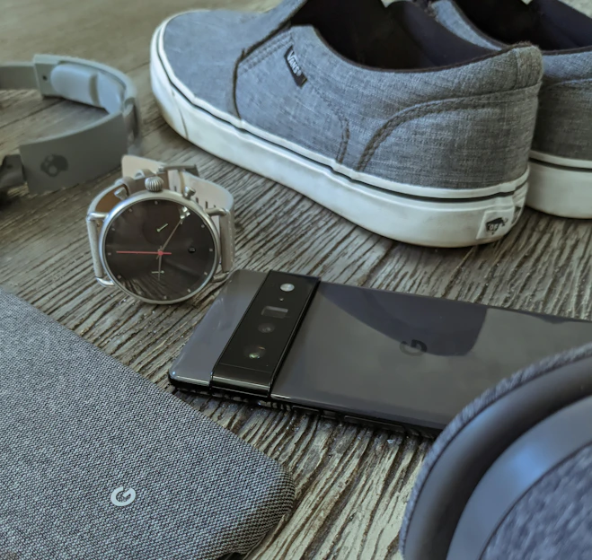 a pair of shoes and a smart phone on a table