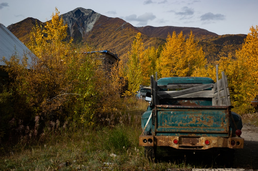 a truck parked on the side of a dirt road