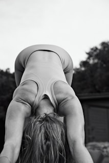 a woman is doing a handstand on her head