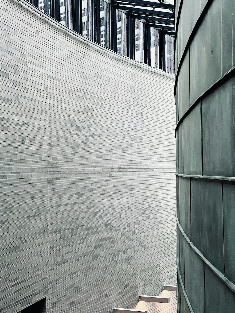 a man walking down a flight of stairs next to a building