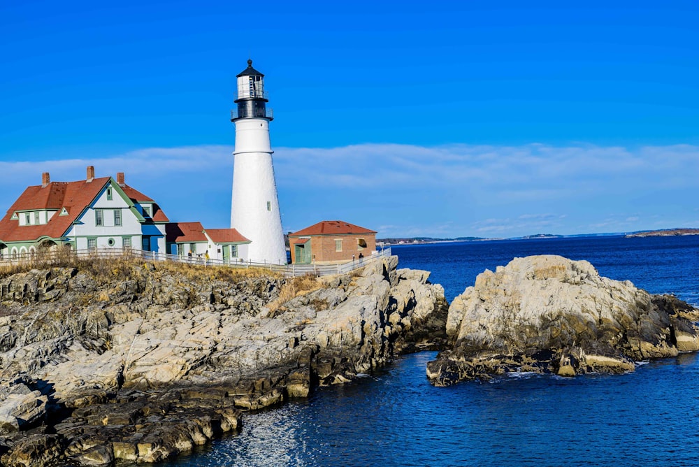 a light house sitting on top of a cliff next to the ocean