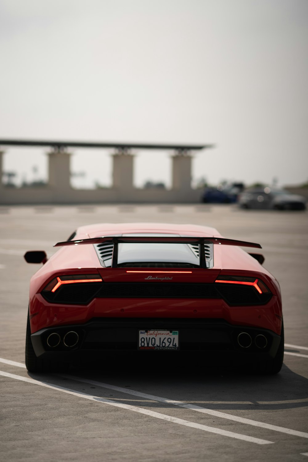 a red sports car parked in a parking lot