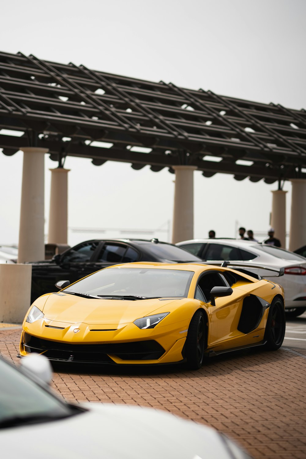 a yellow sports car parked in a parking lot