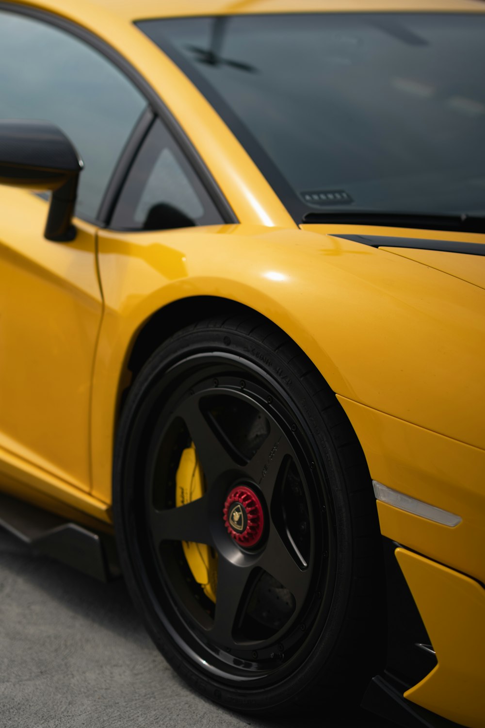 a yellow sports car parked in a parking lot