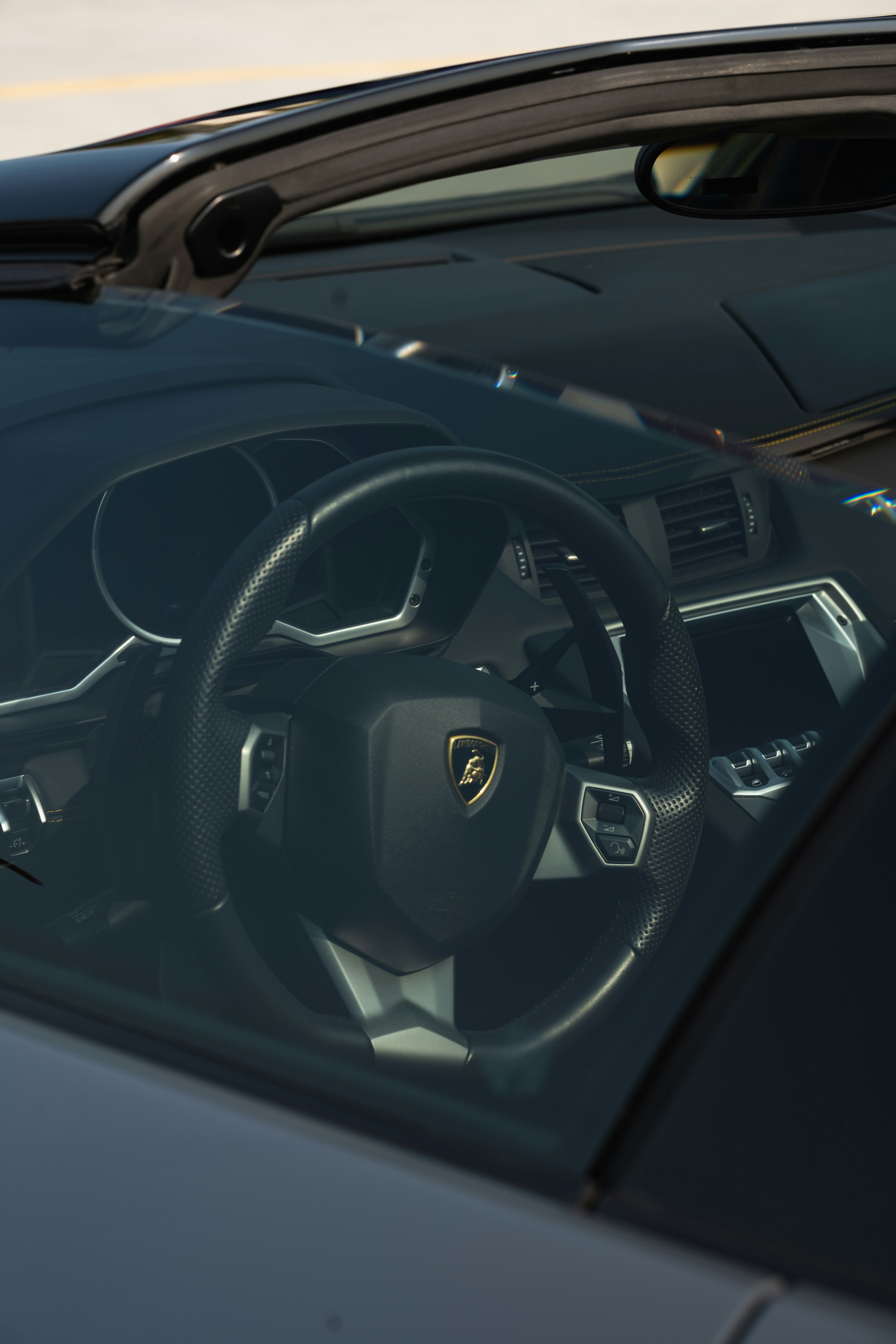 the interior of a car with a steering wheel and dashboard