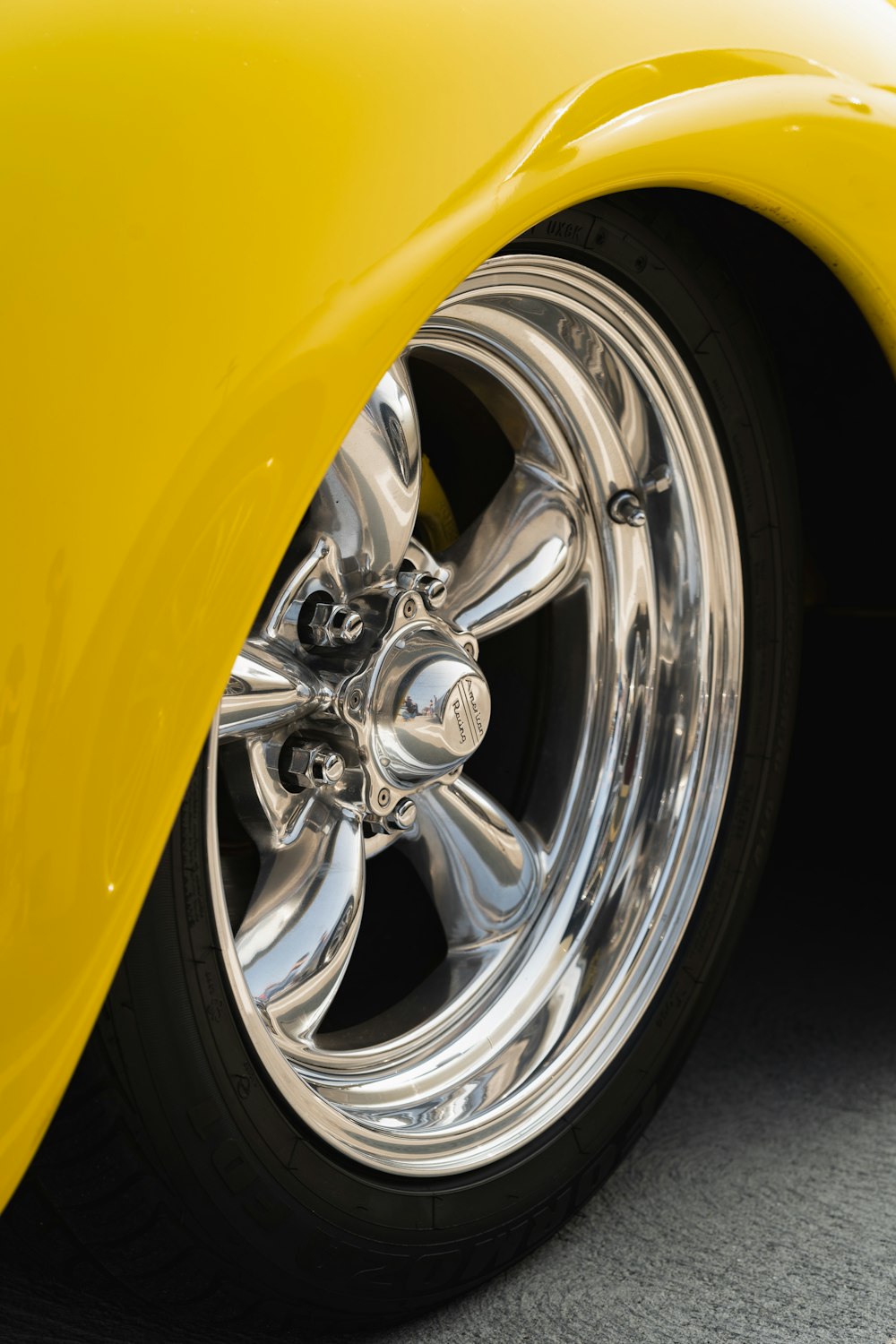 a close up of a yellow car tire