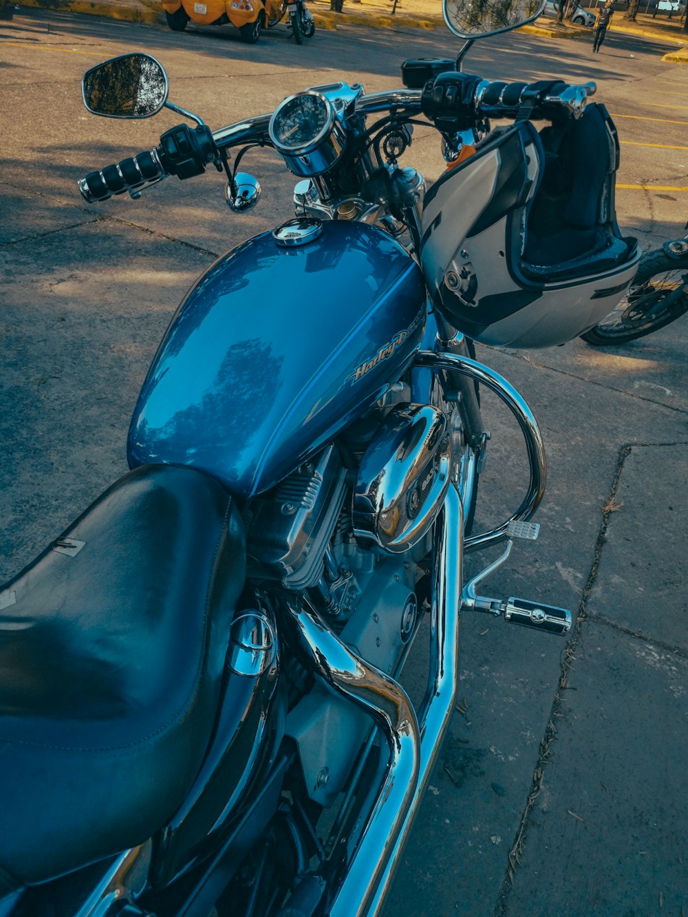 a blue motorcycle parked on the side of the road
