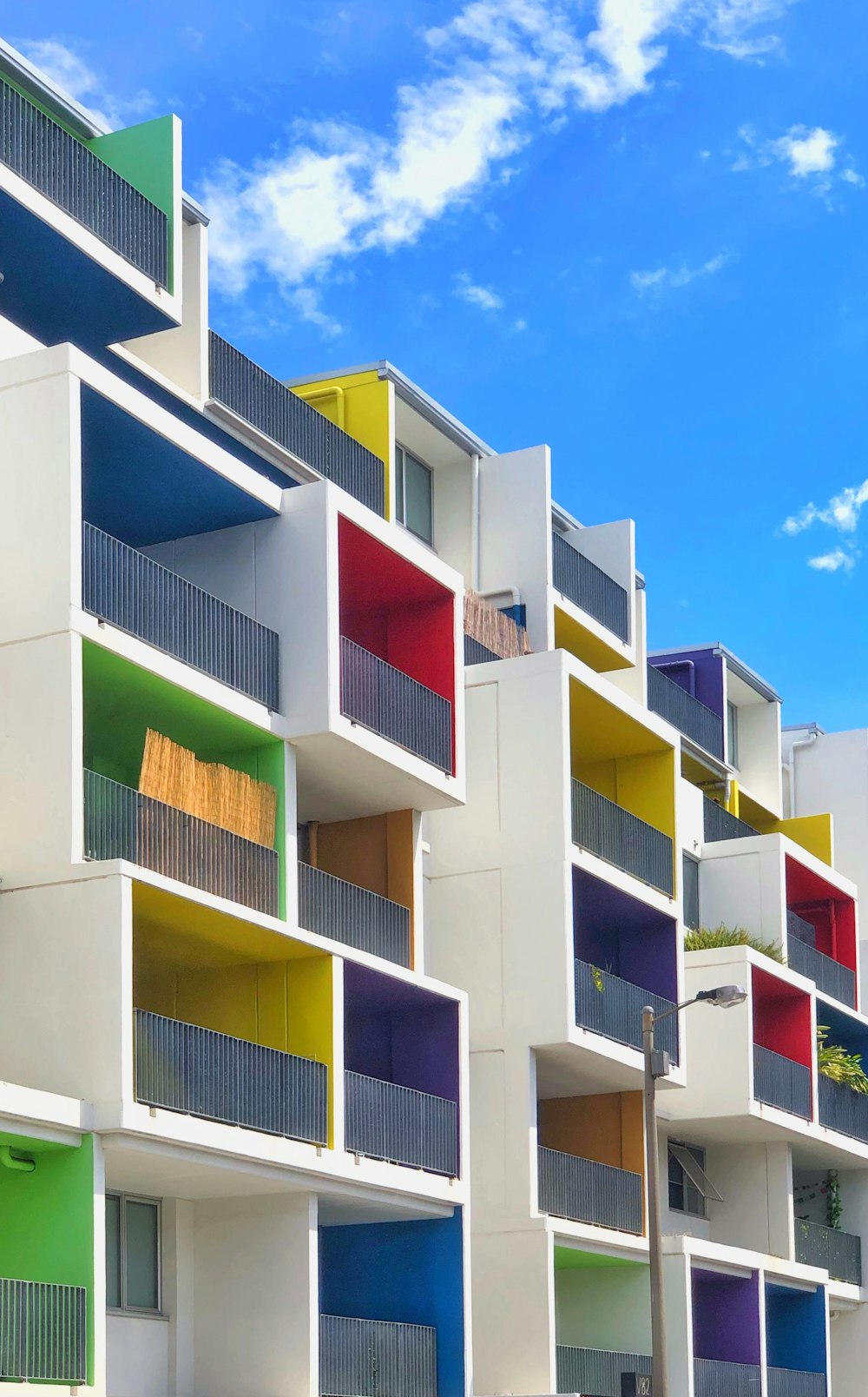 a multicolored building with balconies and balconies