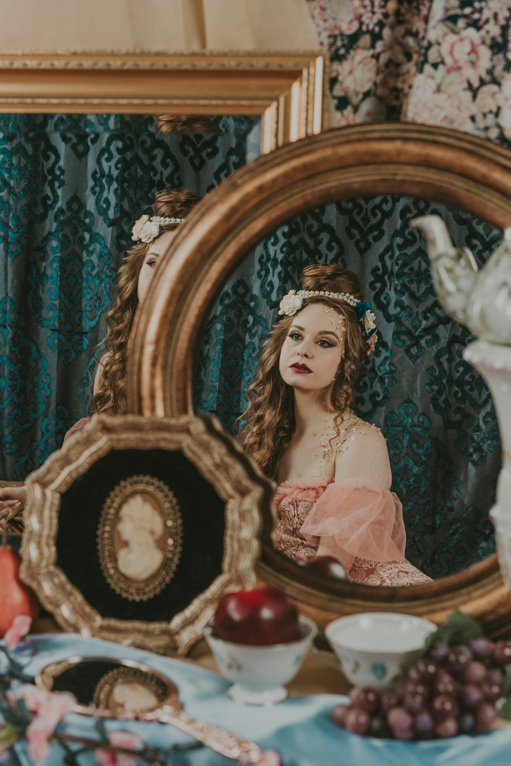 a woman is sitting in front of a mirror